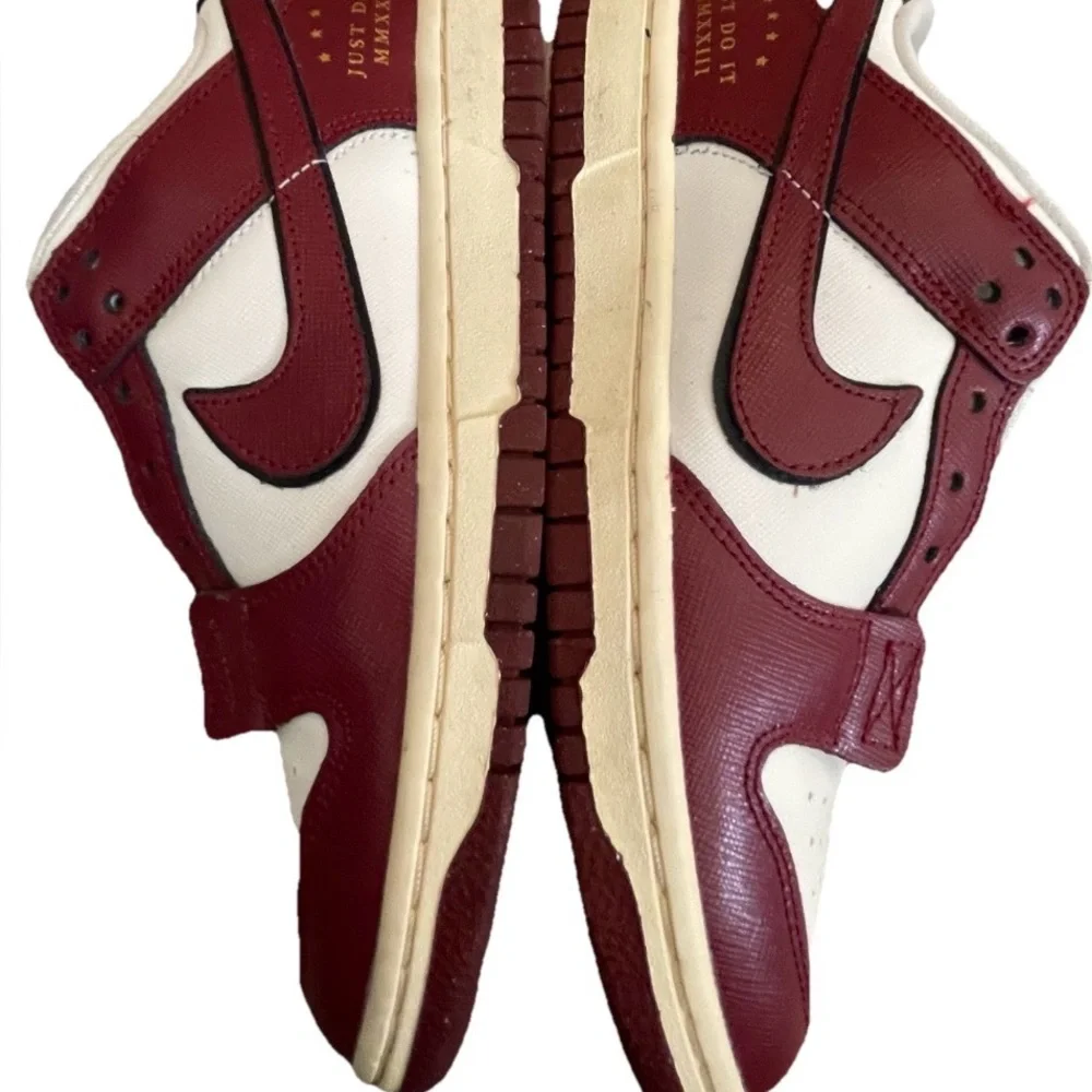 Nike Women’s White and Burgundy Sneakers with Gold Accents